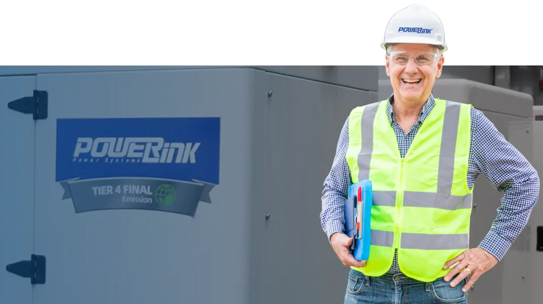 PowerLink engineer in hi-vis vest beside a generator